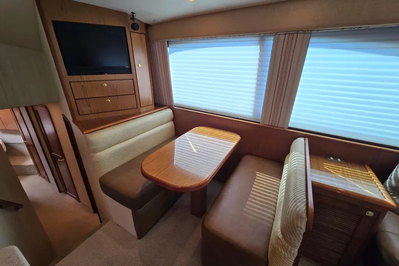 Slide: The Image of 2007 Ocean Yachts 46 Super Sport interior with dining area and TV. - 17