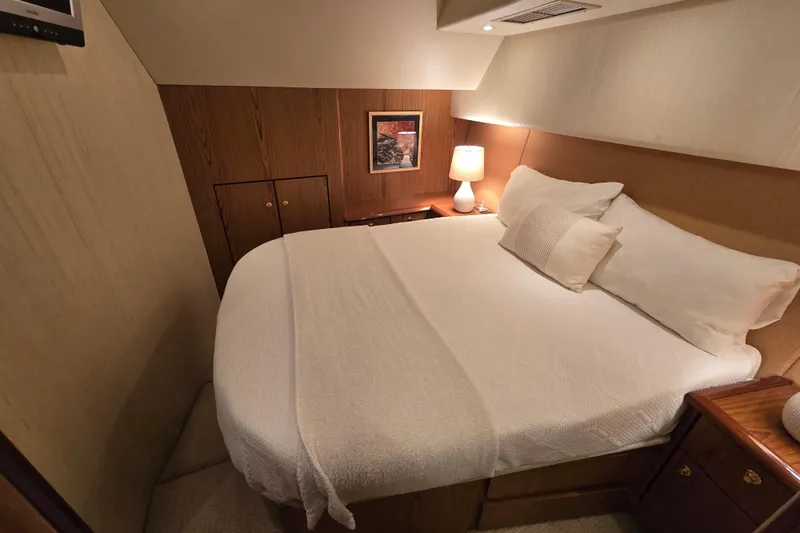 Slide: The Image of Luxurious bedroom interior of 2007 Ocean Yachts 46 Super Sport with cozy bedding and warm lighting. - 24