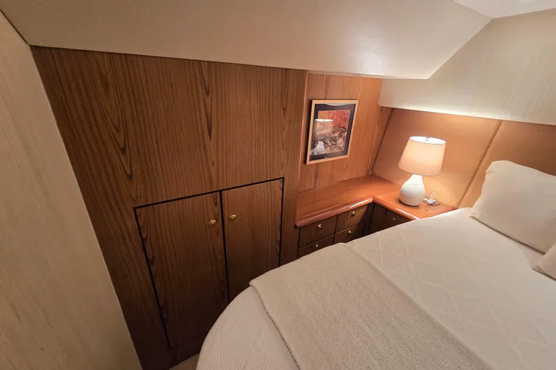 Slide: The Image of Luxurious cabin interior of 2007 Ocean Yachts 46 Super Sport with wood paneling and cozy lighting. - 26