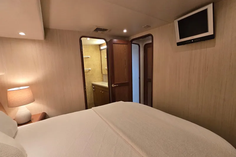 Slide: The Image of Bedroom interior of 2007 Ocean Yachts 46 Super Sport with ensuite bathroom and TV. - 27