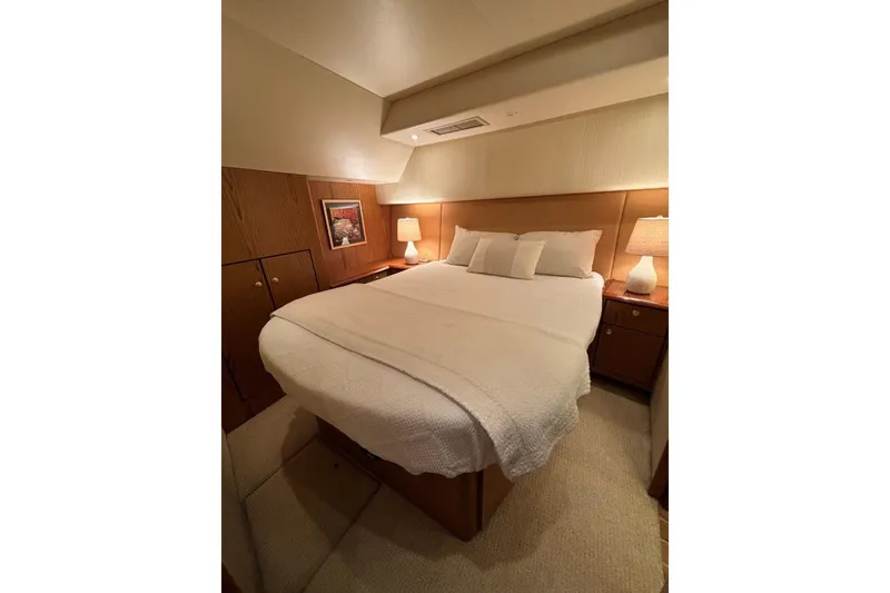 Slide: The Image of Luxurious bedroom interior of 2007 Ocean Yachts 46 Super Sport, featuring cozy bed and warm lighting. - 28