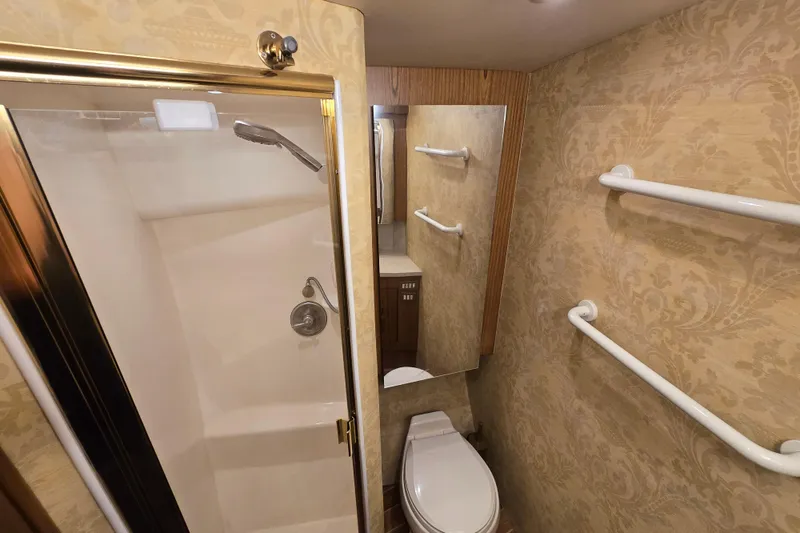 Slide: The Image of Luxurious bathroom in 2007 Ocean Yachts 46 Super Sport with shower and elegant wallpaper. - 29