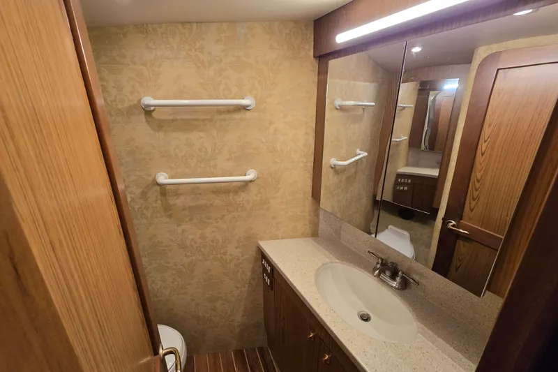 Slide: The Image of Luxurious bathroom in 2007 Ocean Yachts 46 Super Sport, featuring elegant wood and modern fixtures. - 30