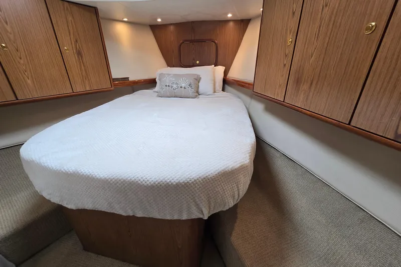 Slide: The Image of Luxurious cabin interior of 2007 Ocean Yachts 46 Super Sport with cozy bed and wooden cabinets. - 32
