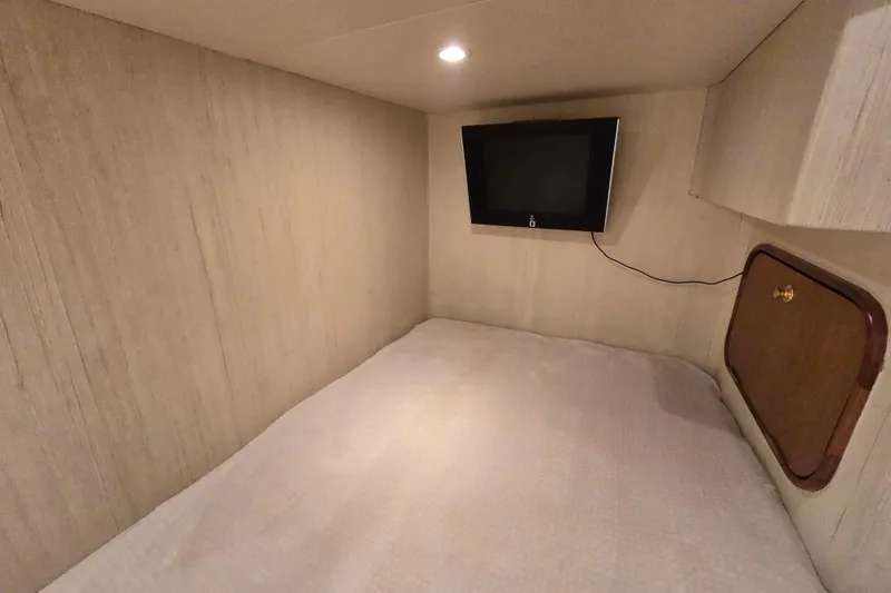 Slide: The Image of Cozy cabin interior of 2007 Ocean Yachts 46 Super Sport with TV and storage. - 39