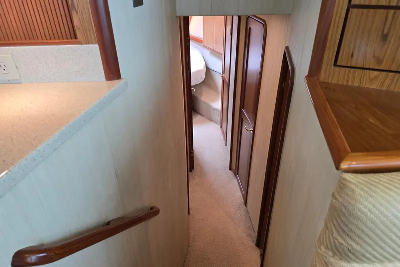 Slide: The Image of Interior hallway of 2007 Ocean Yachts 46 Super Sport, featuring wood accents and carpeted flooring. - 43
