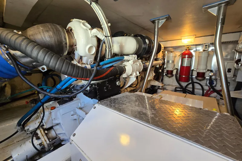 Slide: The Image of Engine room of 2007 Ocean Yachts 46 Super Sport, featuring mechanical components and fire extinguisher. - 68