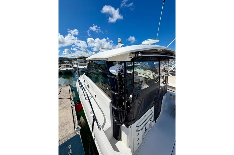 Slide: The Image of 2023 Boston Whaler 345 Conquest docked under a clear blue sky. - 4