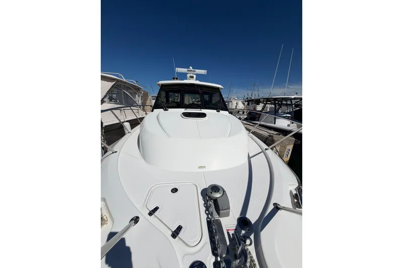 Slide: The Image of 2023 Boston Whaler 345 Conquest boat docked at marina under clear blue sky. - 5