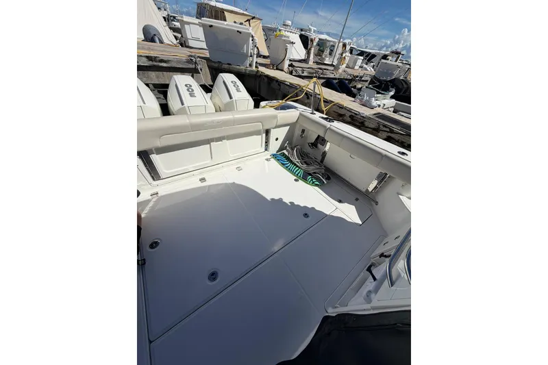 Slide: The Image of 2023 Boston Whaler 345 Conquest boat deck with twin engines at dock. - 6