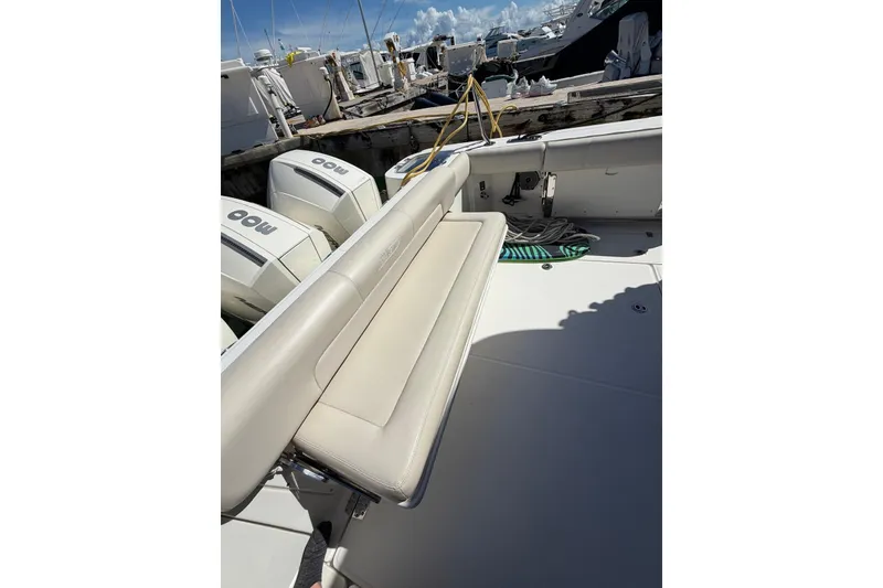 Slide: The Image of 2023 Boston Whaler 345 Conquest boat deck with seating and twin outboard engines. - 7