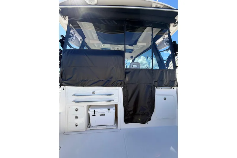 Slide: The Image of 2023 Boston Whaler 345 Conquest boat with black cover and Yeti cooler. - 8