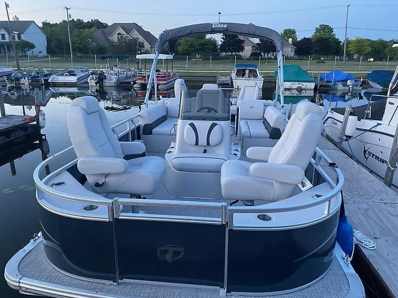 Slide: The Image of 2022 Tahoe GT 2585 CCF Tritoon at dock, luxurious seating. - 2