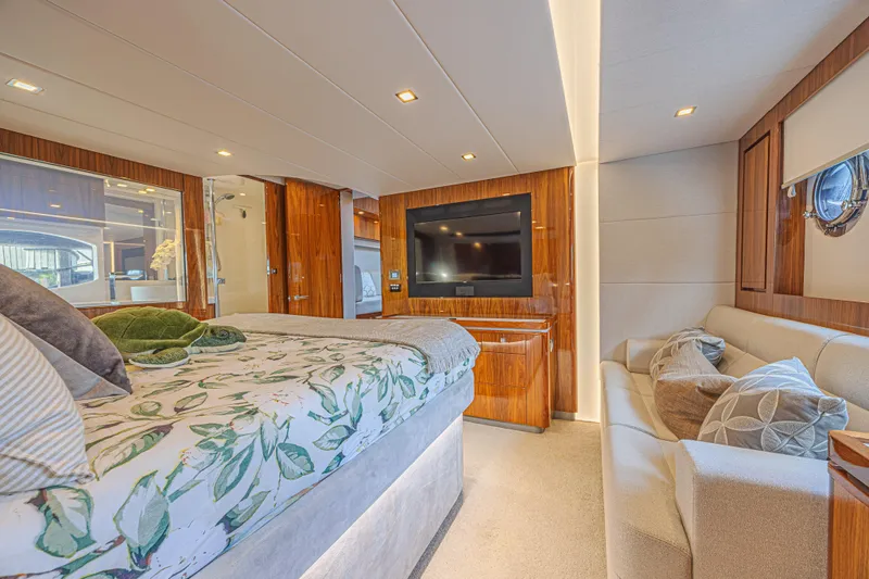 Slide: The Image of Luxurious interior of 2021 Riviera 6000 Sport Yacht Platinum Edition with elegant wood finishes. - 23