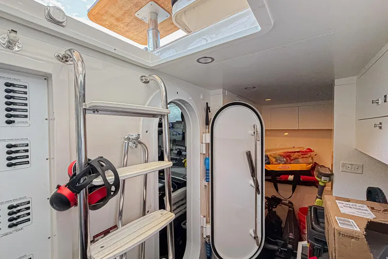 Slide: The Image of Interior of 2021 Riviera 6000 Sport Yacht Platinum Edition, featuring ladder and storage area. - 33