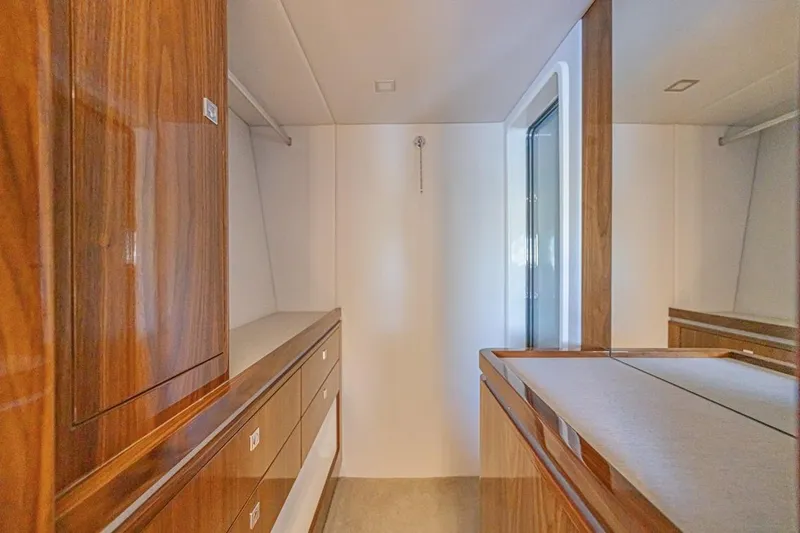 Slide: The Image of Luxurious interior of 2021 Riviera 6000 Sport Yacht Platinum Edition with elegant wood finishes. - 34