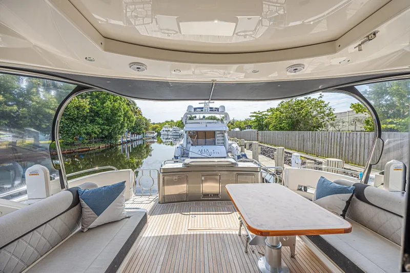 Slide: The Image of Luxurious 2021 Riviera 6000 Sport Yacht Platinum Edition interior with scenic marina view. - 5