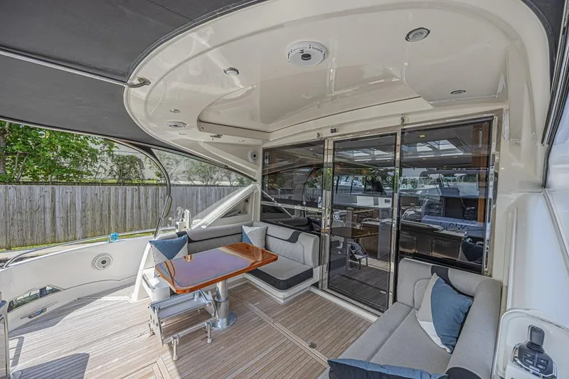 Slide: The Image of 2021 Riviera 6000 Sport Yacht Platinum Edition, luxurious outdoor seating area with elegant design. - 7