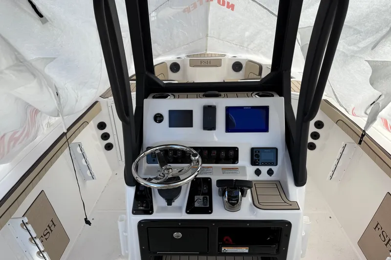 Slide: The Image of 2025 Yamaha Boats 222 FSH Sport E dashboard with steering wheel and navigation controls. - 3