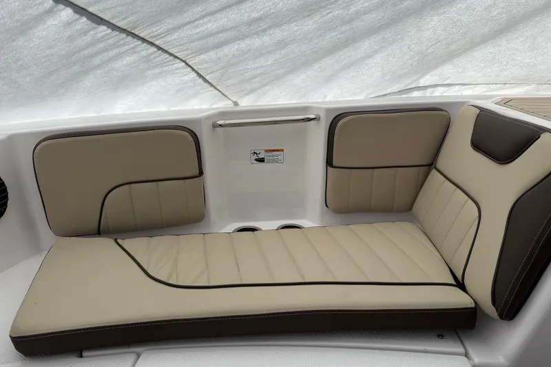 Slide: The Image of 2025 Yamaha Boats 222 FSH Sport E interior seating with beige and black upholstery. - 7
