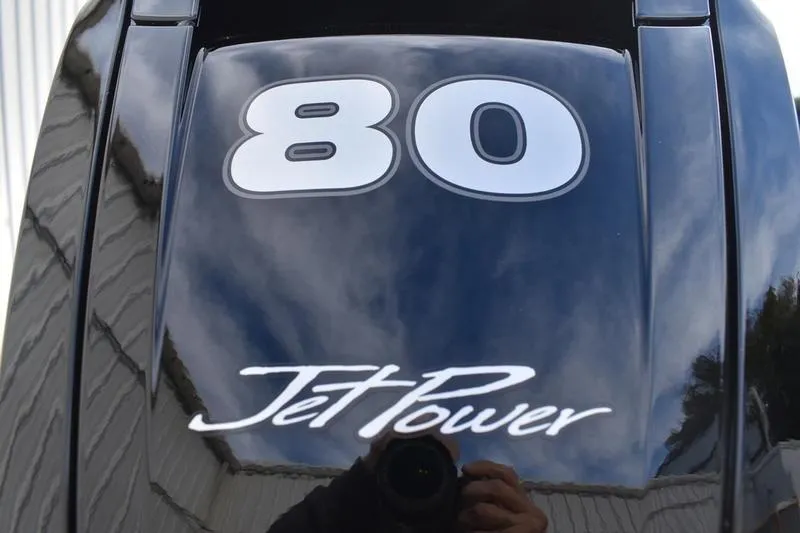 Slide: The Image of 2026 Lowe Roughneck RX1860 Tunnel Jet, black exterior with '80 Jet Power' branding. - 10