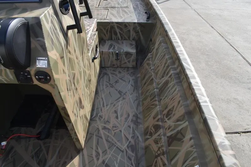 Slide: The Image of 2026 Lowe Roughneck RX1860 Tunnel Jet boat interior with camouflage design. - 18