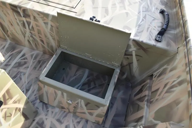 Slide: The Image of 2026 Lowe Roughneck RX1860 Tunnel Jet boat with open storage compartment, camo design. - 21