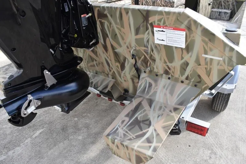 Slide: The Image of 2026 Lowe Roughneck RX1860 Tunnel Jet boat with camouflage design and powerful outboard motor. - 3