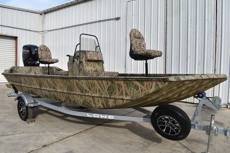 Slide: The Image of 2026 Lowe Roughneck RX1860 Tunnel Jet boat with camouflage design on a trailer. - 5