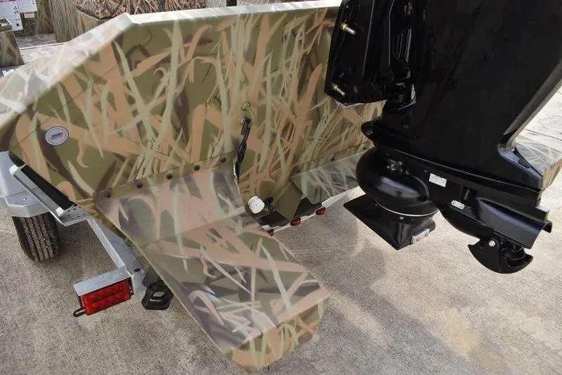 Slide: The Image of 2026 Lowe Roughneck RX1860 Tunnel Jet boat with camouflage design and outboard motor. - 8