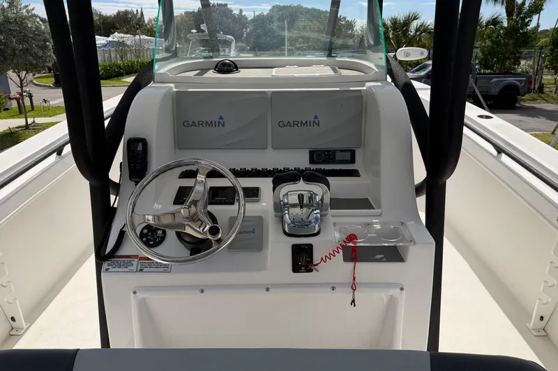 Slide: The Image of 2021 Twin Vee 310 CC GF boat console with Garmin navigation system and steering wheel. - 6