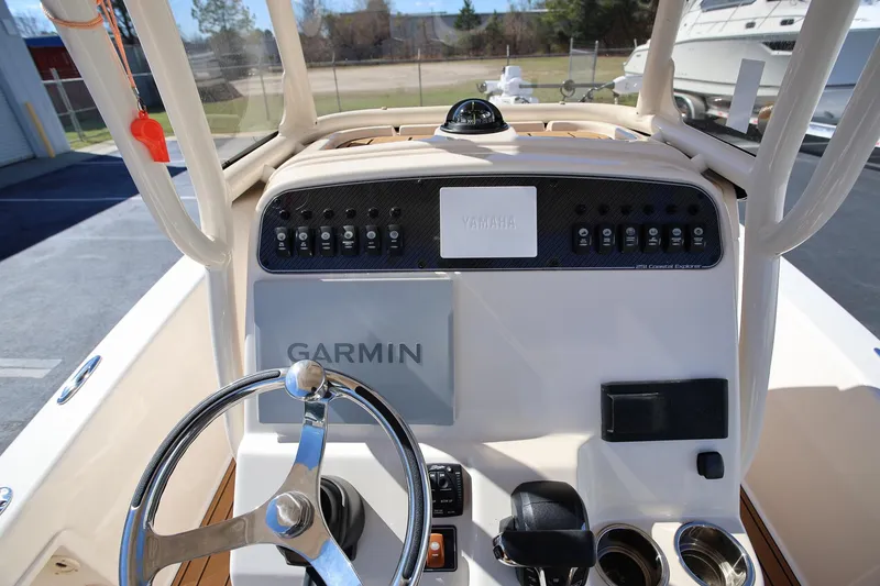 Slide: The Image of 2024 Grady-White 251 Coastal Explorer boat dashboard with Garmin and Yamaha controls. - 11