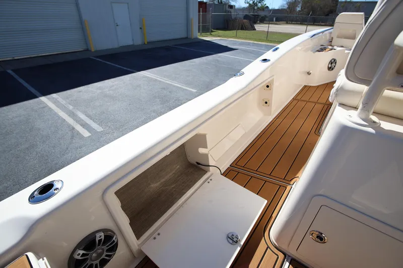 Slide: The Image of 2024 Grady-White 251 Coastal Explorer boat interior with teak flooring and storage compartments. - 15