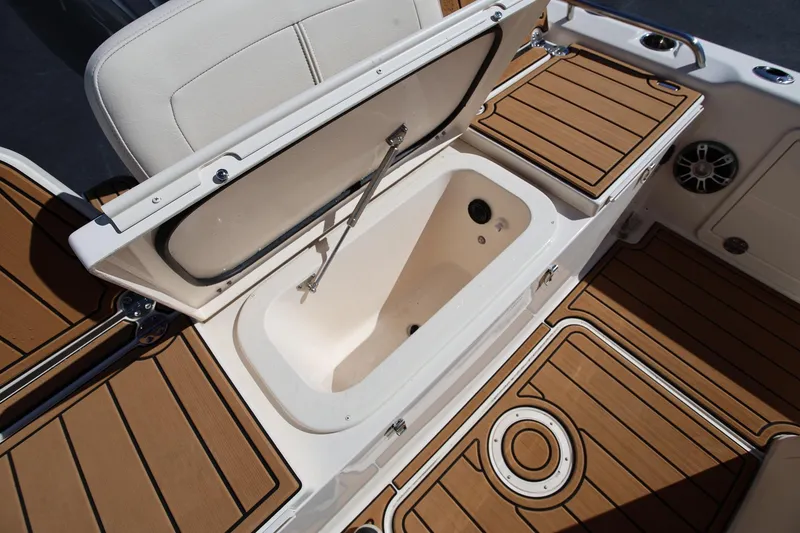 Slide: The Image of 2024 Grady-White 251 Coastal Explorer boat with open storage compartment and teak flooring. - 17