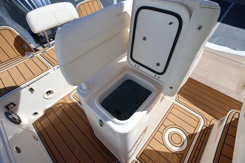 Slide: The Image of 2024 Grady-White 251 Coastal Explorer boat interior with open storage compartment. - 18