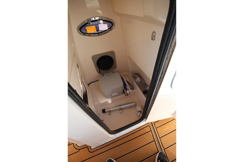 Slide: The Image of 2024 Grady-White 251 Coastal Explorer interior storage compartment with equipment and accessories. - 19