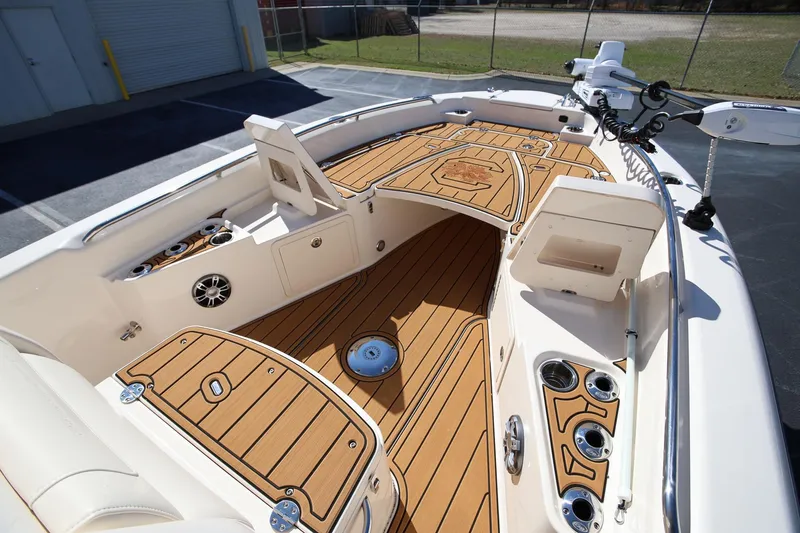 Slide: The Image of 2024 Grady-White 251 Coastal Explorer boat interior with teak flooring and fishing amenities. - 21