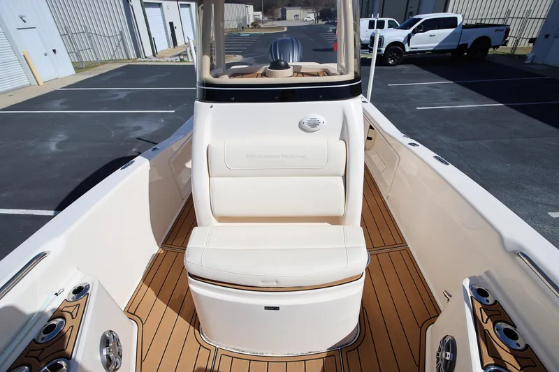 Slide: The Image of 2024 Grady-White 251 Coastal Explorer boat interior with seating and wood finish. - 24