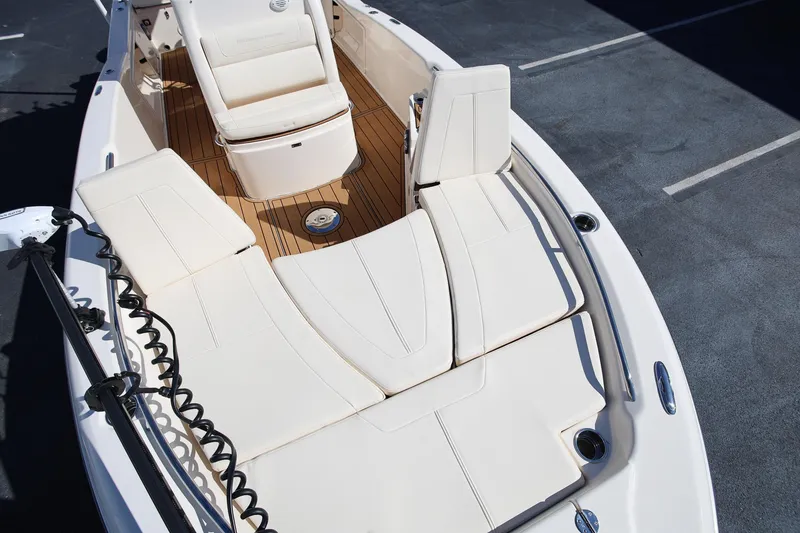 Slide: The Image of 2024 Grady-White 251 Coastal Explorer boat interior with cushioned seating and teak flooring. - 26