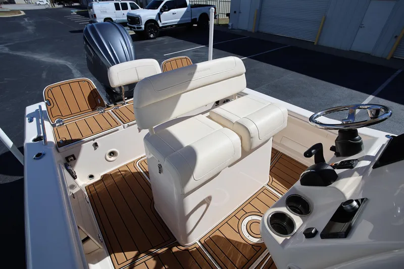 Slide: The Image of 2024 Grady-White 251 Coastal Explorer boat interior with seating and steering wheel. - 8