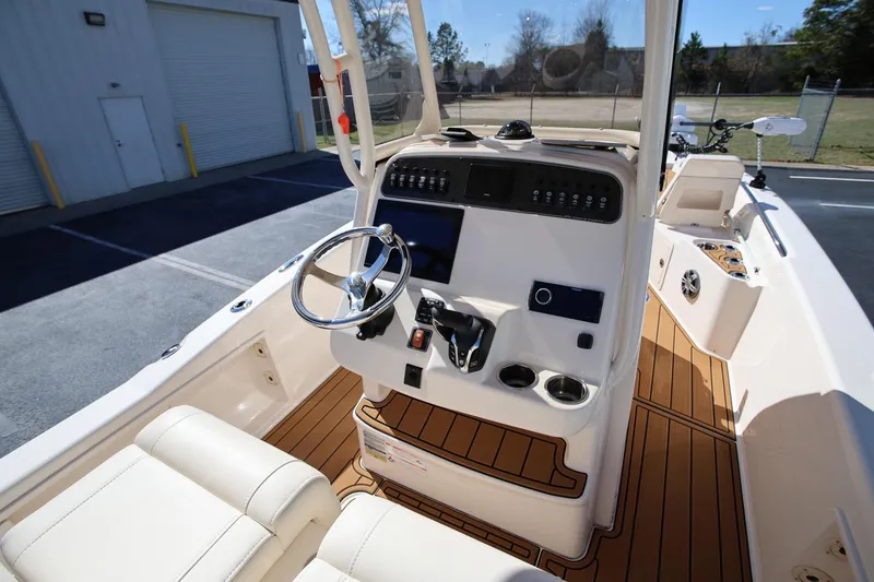Slide: The Image of 2024 Grady-White 251 Coastal Explorer boat interior with modern helm and seating. - 9