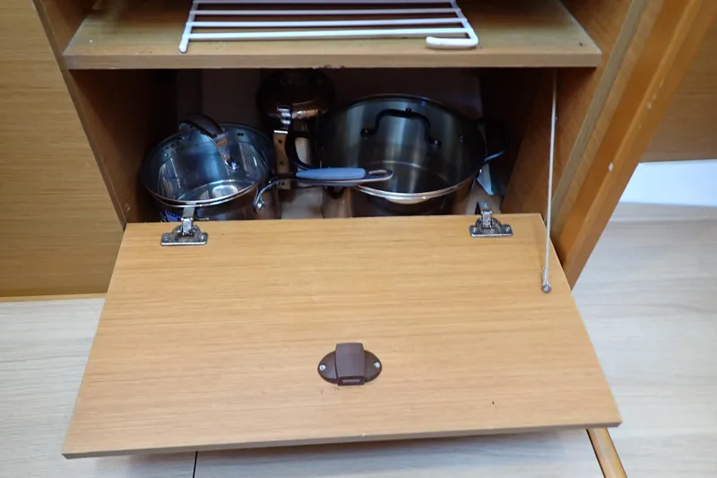 Slide: The Image of Cabinet with cookware in 2018 Jeanneau Sun Odyssey 389 yacht kitchen. - 108