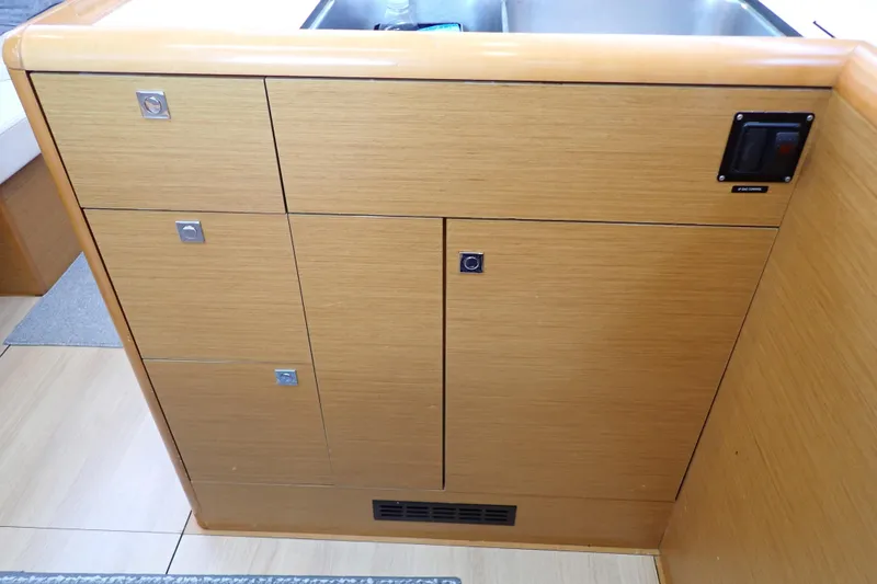 Slide: The Image of Interior cabinetry of 2018 Jeanneau Sun Odyssey 389 sailboat, featuring wooden finish and modern design. - 109
