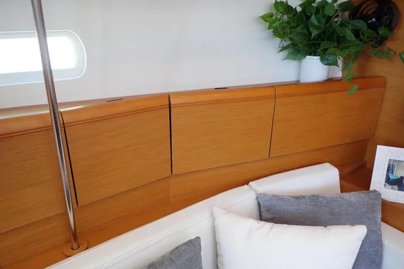Slide: The Image of Interior of 2018 Jeanneau Sun Odyssey 389 yacht with wooden cabinets and cozy seating. - 118