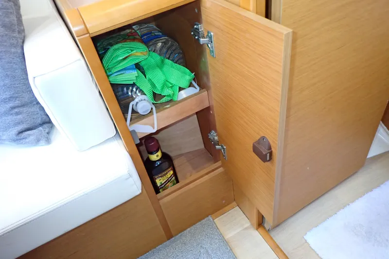 Slide: The Image of Open cabinet on Jeanneau Sun Odyssey 389 yacht, showing storage items and interior details. - 121