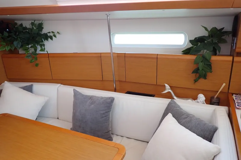 Slide: The Image of Interior of 2018 Jeanneau Sun Odyssey 389 yacht with cozy seating and decorative plants. - 124