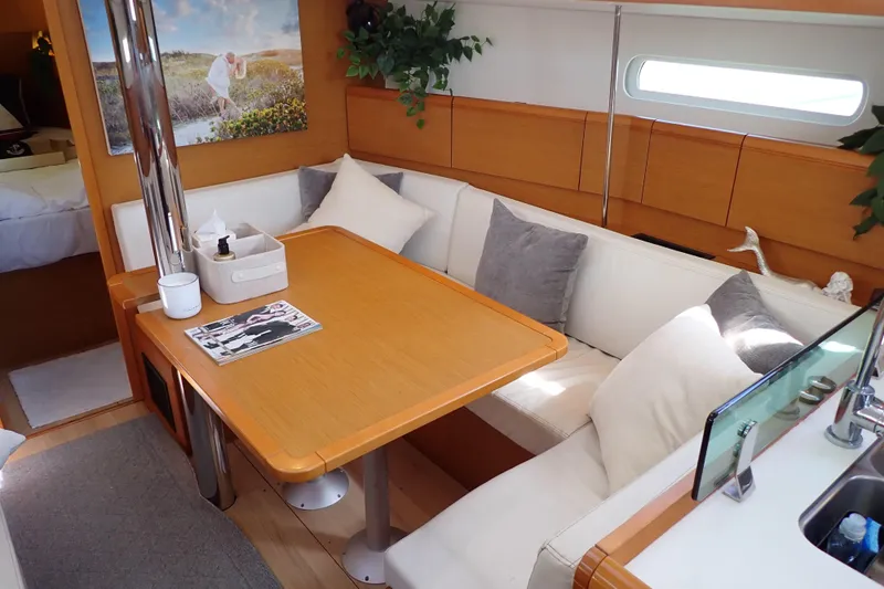 Slide: The Image of Interior of 2018 Jeanneau Sun Odyssey 389 sailboat with cozy seating and dining area. - 13