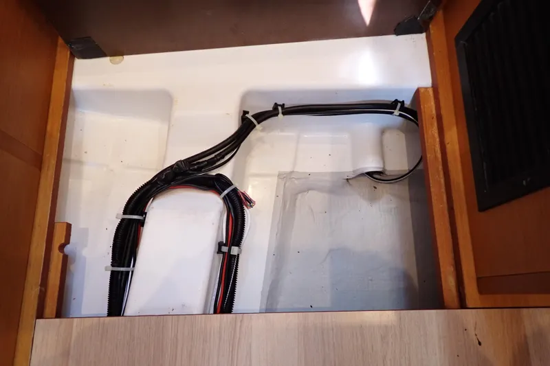 Slide: The Image of Electrical wiring inside a 2018 Jeanneau Sun Odyssey 389 yacht compartment. - 141