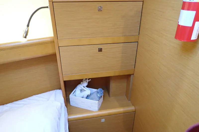 Slide: The Image of Interior of 2018 Jeanneau Sun Odyssey 389 with wooden cabinets and decorative items. - 142