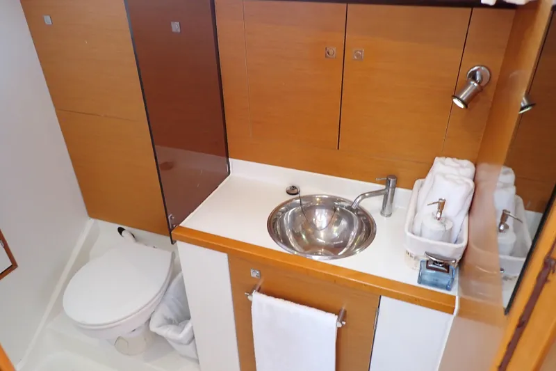 Slide: The Image of Bathroom interior of 2018 Jeanneau Sun Odyssey 389 yacht, featuring sink and toilet. - 15